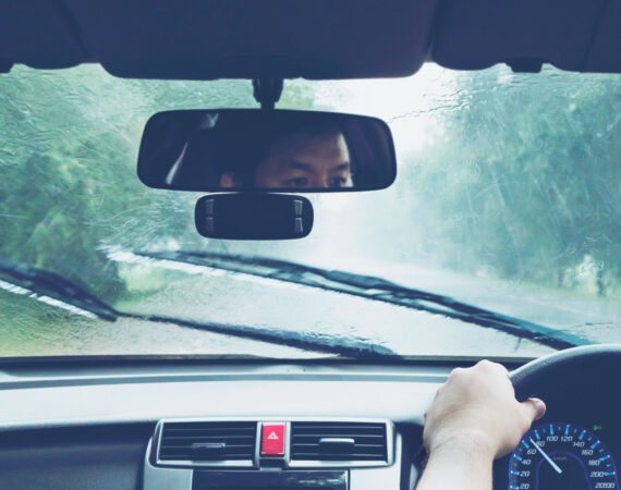 man driving car heavy rainfall